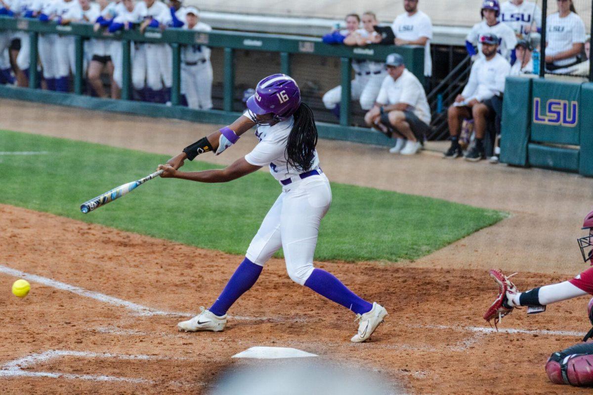 LSU softball freshman utility Savanna Bedell (16) connects with the ball Friday, April 26, 2024, during LSU's 2-1 loss against Arkansas at Tiger Park in Baton Rouge, La.