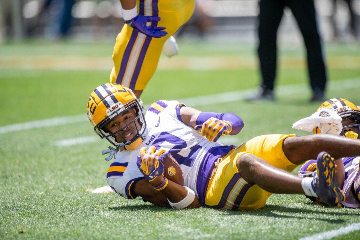 LSU football 5th-year senior wide receiver Kyren Lacy (2) falls on the ground with the ball during the LSU Spring Football game on Saturday, April 13, 2024, in Tiger Stadium.