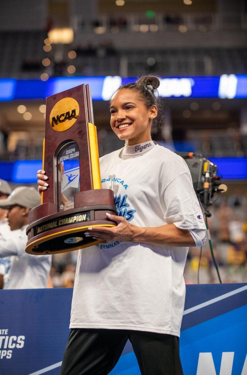 LSU gymnastics all-around Haleigh Bryant holds up the trophy and smiles for a picture following LSU's NCAA Championship win on Saturday, April 20, 2024, in Fort Worth, Tx.