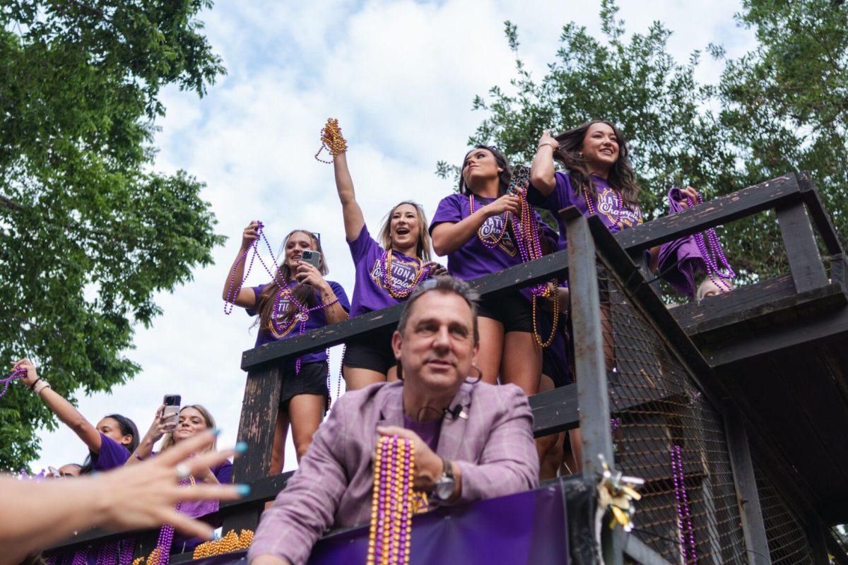 Members of the LSU gymnastics team throw beads from a float Wednesday, April 24, 2024, at the LSU gymnastics championship parade on LSU's campus in Baton Rouge, La.