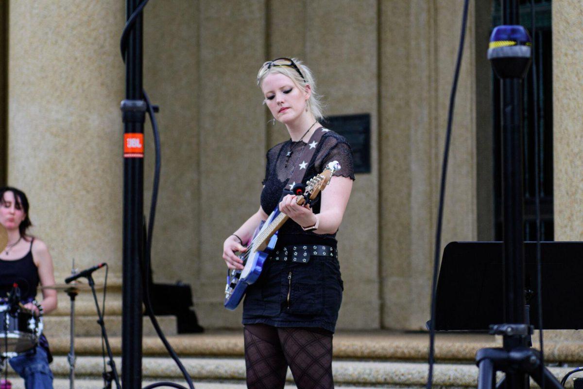 The guitarist performs to the audience on Tuesday, April 16, 2024, in front of Memorial Tower in Baton Rouge, La.