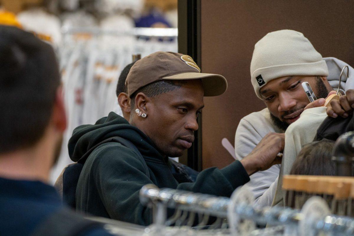 Travis Scott autographs a sweater Thursday, April 4, 2024, at the Barnes &amp; Nobles at LSU in Baton Rouge, La.