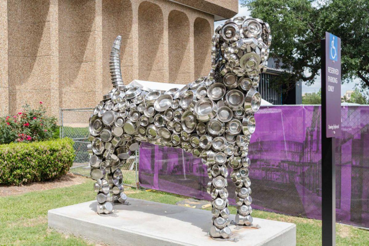 A dog statue made of dog bowls sits Friday, April 26, 2024, outside of the LSU School of Veterinary Medicine in Baton Rouge, La.