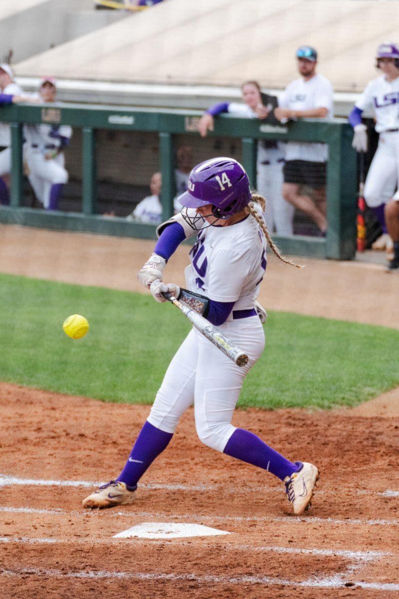 LSU softball graduate student infielder Karli Petty (14) swings at the pitch Friday, April 26, 2024, during LSU's 2-1 loss against Arkansas at Tiger Park in Baton Rouge, La.