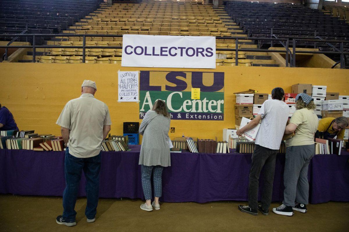 Attendees browse collectors items Sunday, April 14, 2024, during the Friends of the LSU Libraries Book Bazaar at the John M. Parker Agricultural Coliseum in Baton Rouge, La.