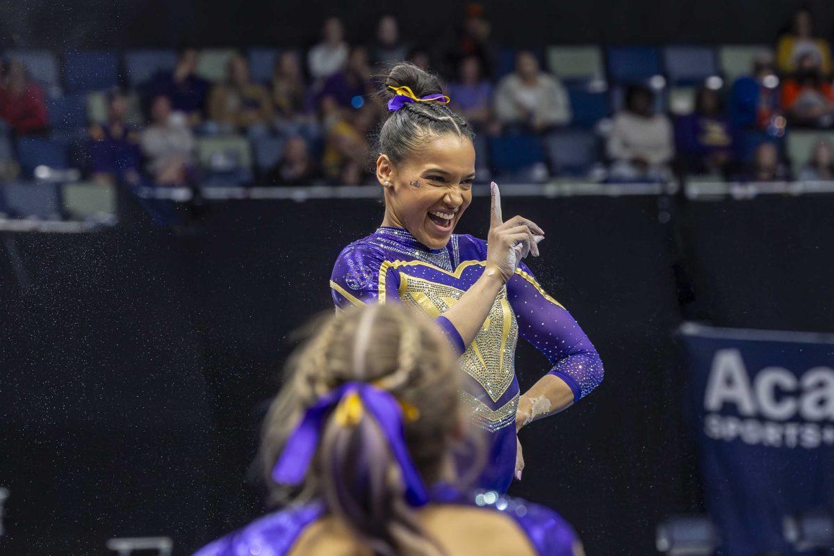 LSU gymnastics senior all-around Haleigh Bryant strikes a pose Saturday, March 23, 2024, during LSU's 198.075 victory in the 2024 SEC Gymnastics Championship in the Smoothie King Center in New Orleans, La.