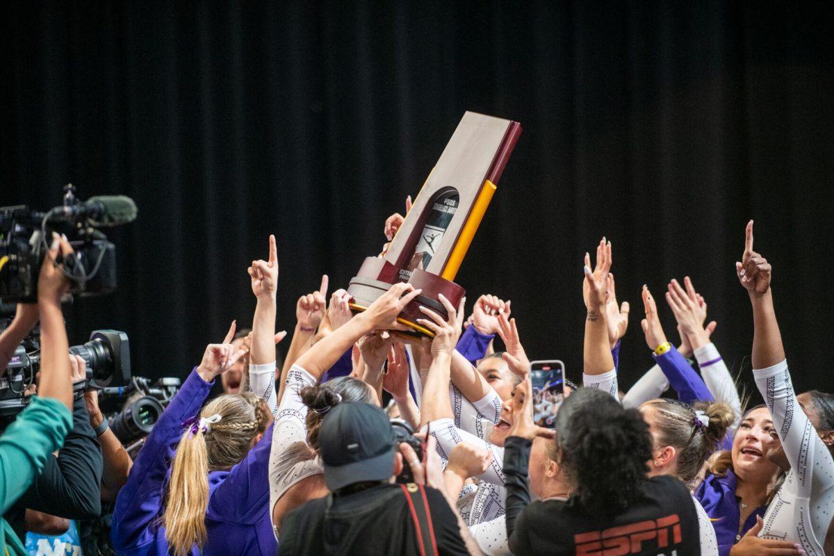 The LSU gymnastics team gets handed the trophy following LSU's NCAA Championship win on Saturday, April 20, 2024, in Fort Worth, Tx.