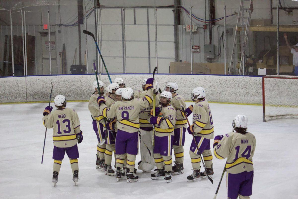 LSU Ice Hockey Club players huddled up on the ice.&#160;