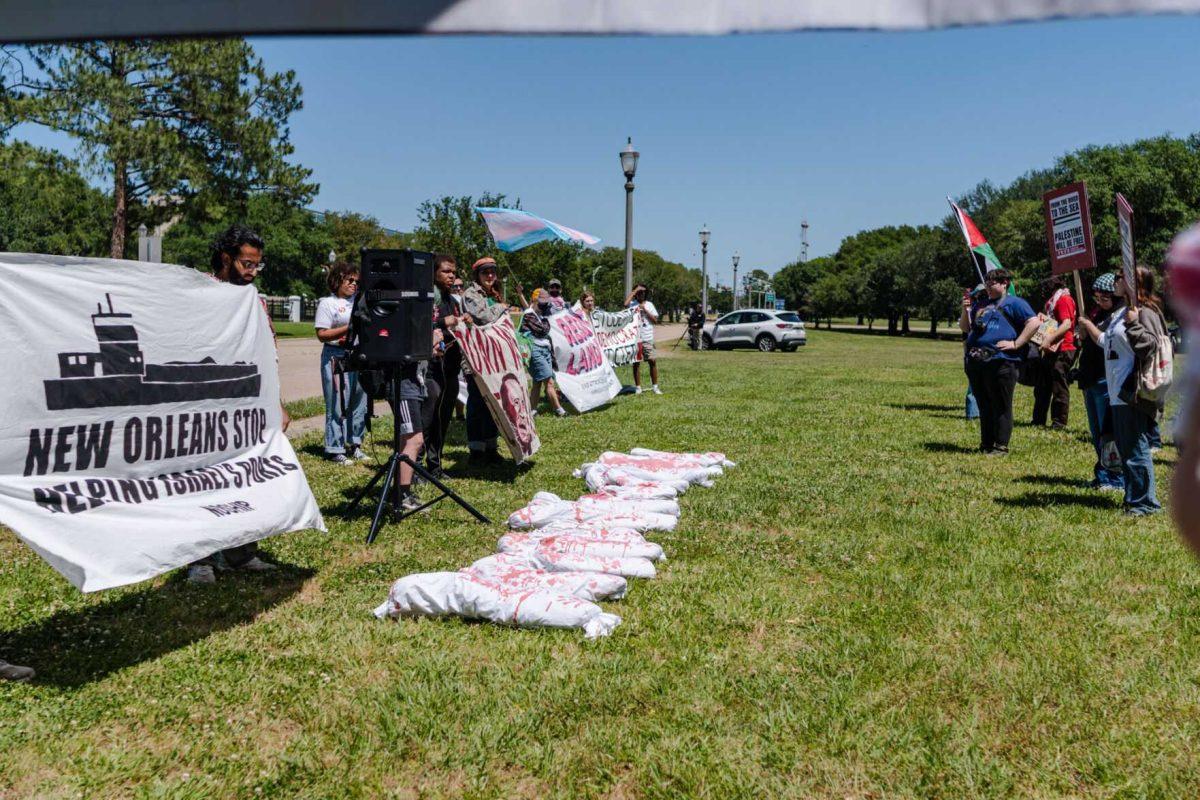 Bags respresenting bloody, dead bodies sit in the grass Monday, April 22, 2024, during a protest outside the Governor's mansion in Baton Rouge, La.