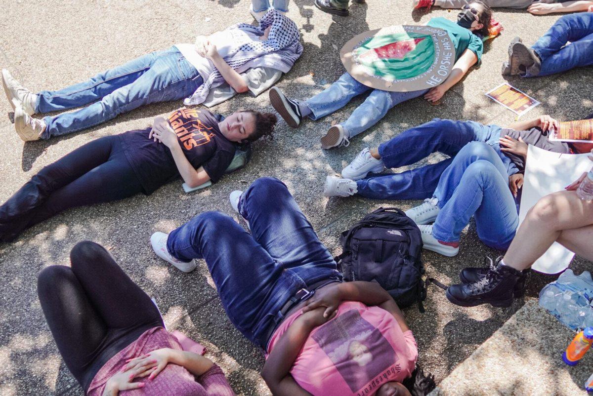 Students lie on the LSU Student Union steps Thursday, April 25, 2024, during the Die-in for Gaza on LSU&#8217;s campus in Baton Rouge, La.