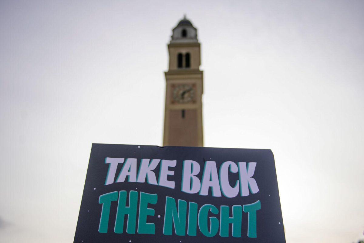 The sign reads "Take Back The Night" on Tuesday, April 16, 2024, in front of Memorial Tower in Baton Rouge, La.