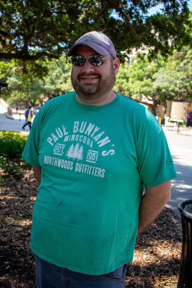 A student artist poses for a picture on Wednesday, April 24, 2024, in Free Speech Alley on LSU's campus.