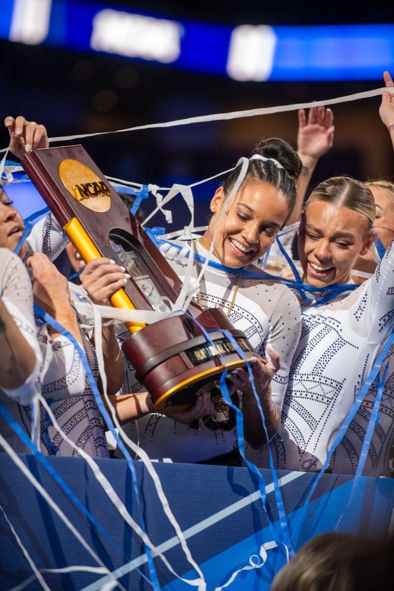 LSU gymnastics all-around Haleigh Bryant smiles while holding the trophy following LSU's NCAA Championship win on Saturday, April 20, 2024, in Fort Worth, Tx.