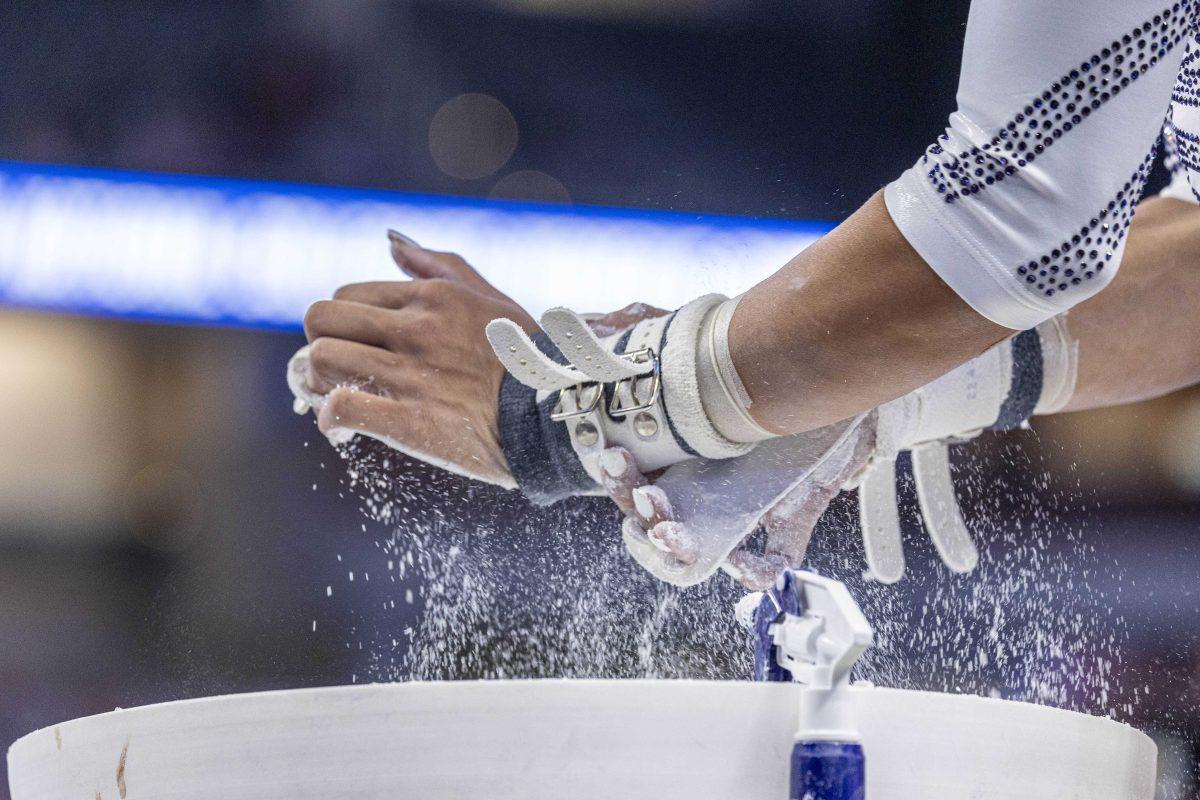 LSU gymnastics all-around senior Haleigh Bryant chalks her hands Saturday, April 20, 2024, during the NCAA Gymnastics Championship in the Dickies Arena in Fort Worth, Tx.