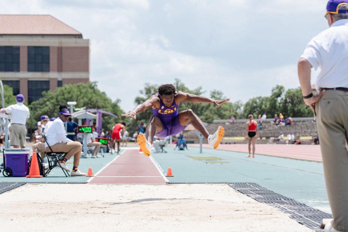 LSU track and field jumps senior Ji'eem Bullock flies through the air as he compete in long jump Saturday, April 27, 2024, at the LSU Invitational in the Bernie Moore Track Stadium in Baton Rouge, La.