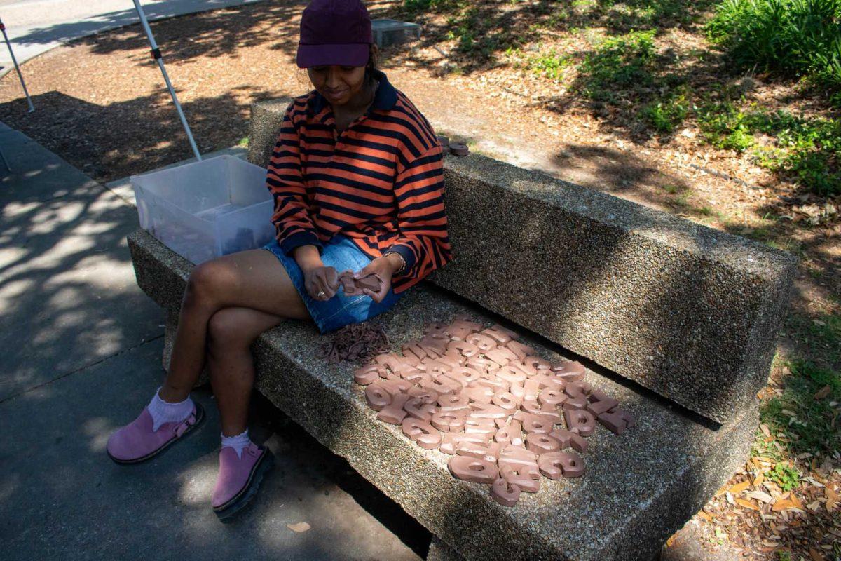 A student works with clay for her final project on Wednesday, April 24, 2024, in Free Speech Alley on LSU's campus.