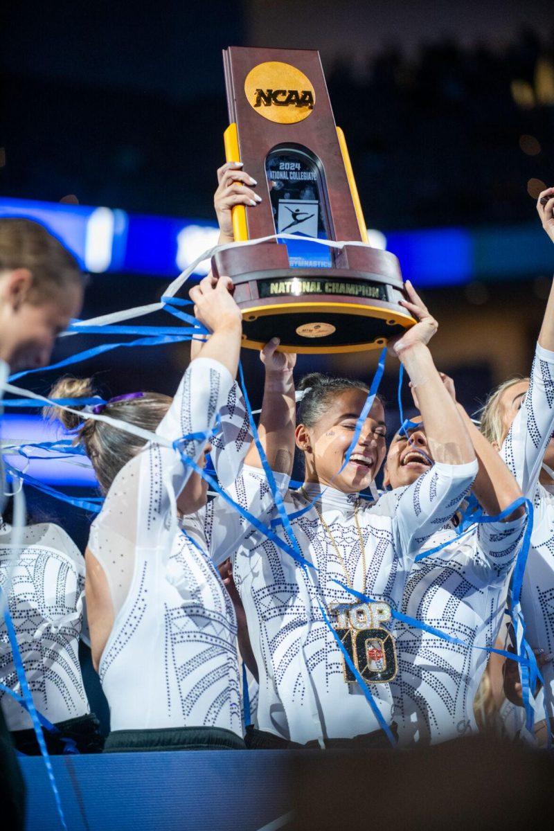 LSU gymnastics all-around Haleigh Bryant holds up the trophy alongside teammates following LSU's NCAA Championship win on Saturday, April 20, 2024, in Fort Worth, Tx.