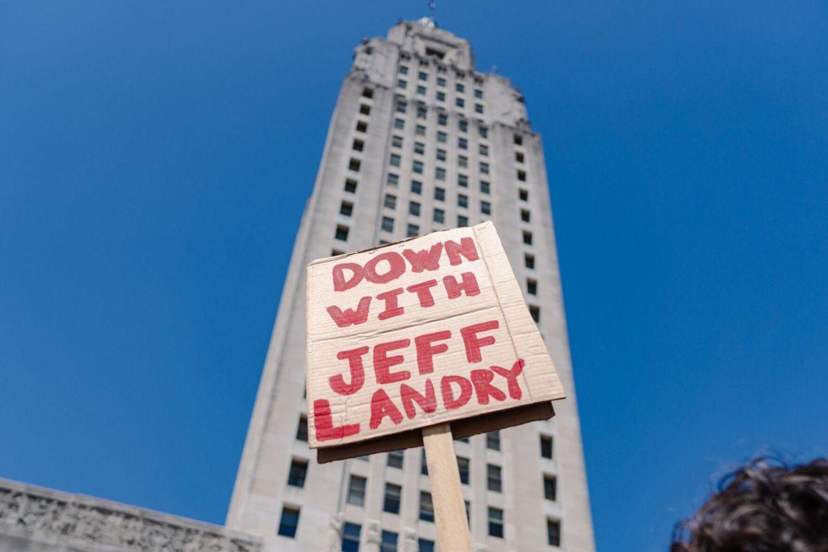 A sign reads "Down with Jeff Landry" Monday, April 22, 2024, at a protest at the Capitol in Baton Rouge, La.