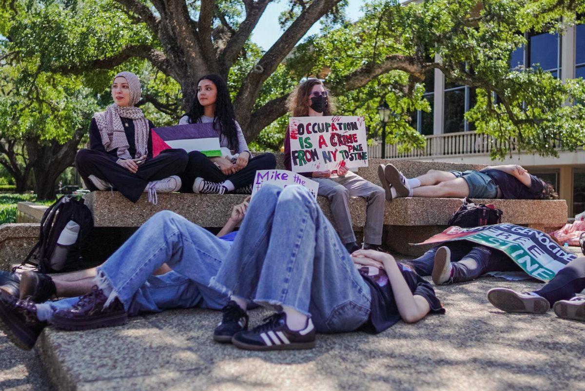 Students lie on the LSU Student Union steps Thursday, April 25, 2024, during the Die-in for Gaza on LSU&#8217;s campus in Baton Rouge, La.