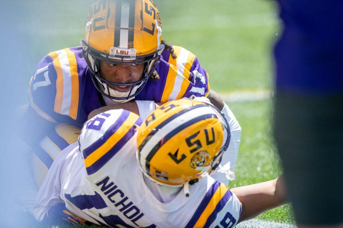 LSU football redshirt junior wide receiver Chris Hilton Jr. (17) tackles football redshirt sophomore wide receiver Javen Nicholas (19) during the LSU Spring Football game on Saturday, April 13, 2024, in Tiger Stadium.