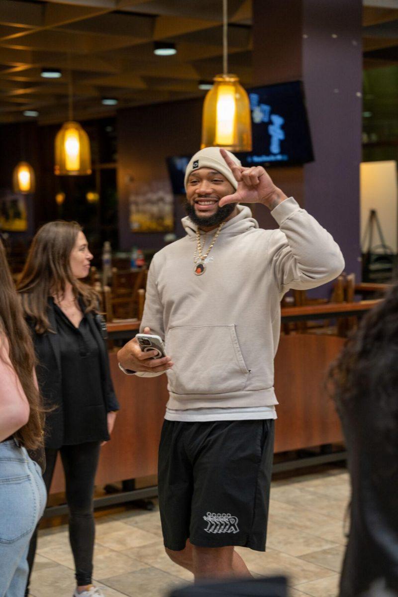 A student holds up the L sign Thursday, April 4, 2024, at the Barnes and Nobles at LSU in Baton Rouge, La