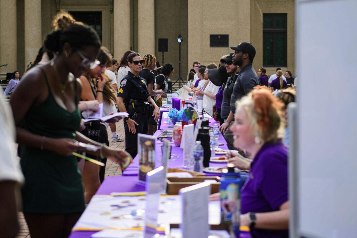 LSU students visit tables on Tuesday, April 16, 2024, in front of Memorial Tower in Baton Rouge, La.