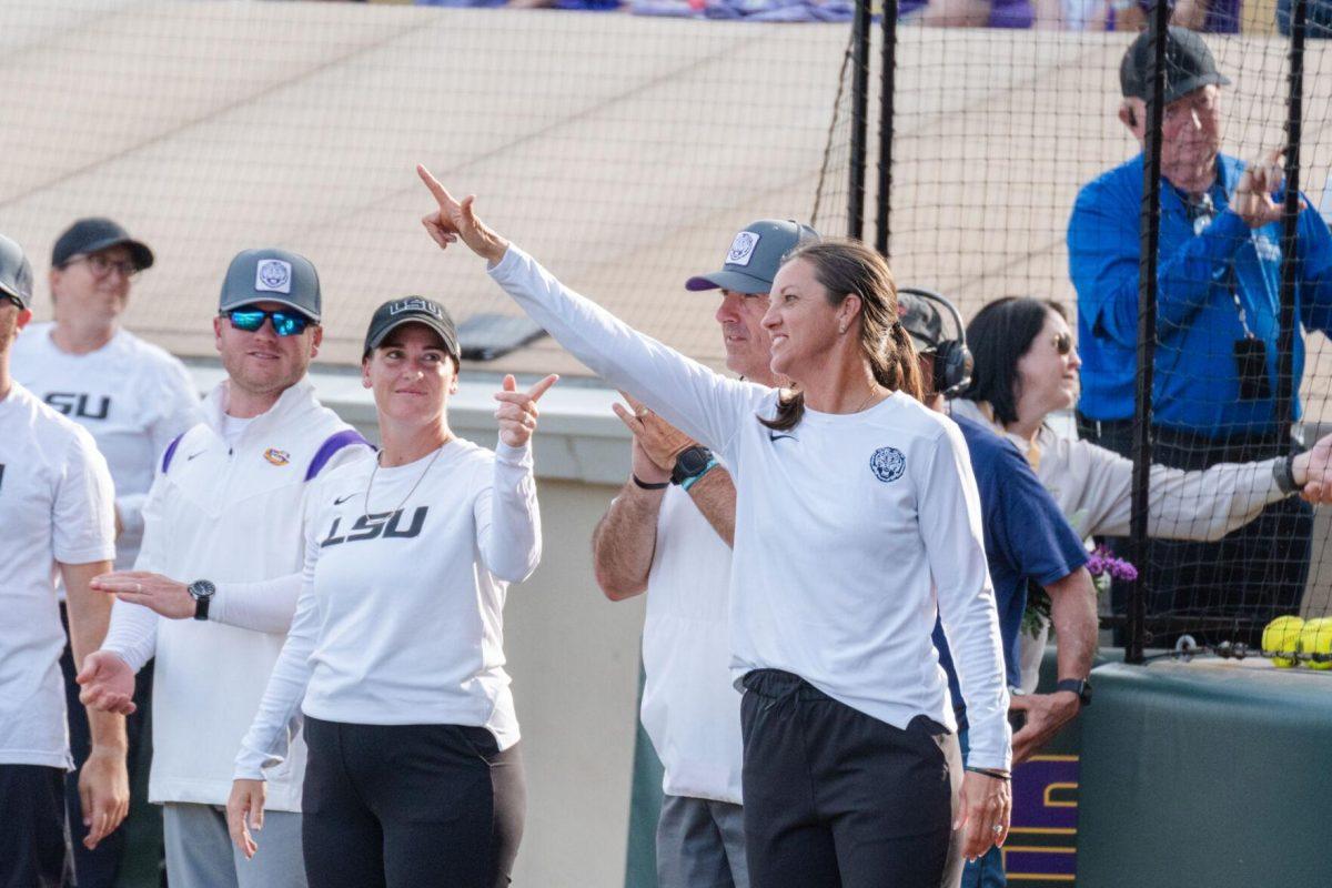 LSU softball head coach Beth Torina holds up an &#8220;L&#8221; Friday, April 26, 2024, during LSU's 2-1 loss against Arkansas at Tiger Park in Baton Rouge, La.