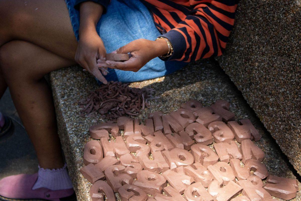 A student works with clay for her final project on Wednesday, April 24, 2024, in Free Speech Alley on LSU's campus.