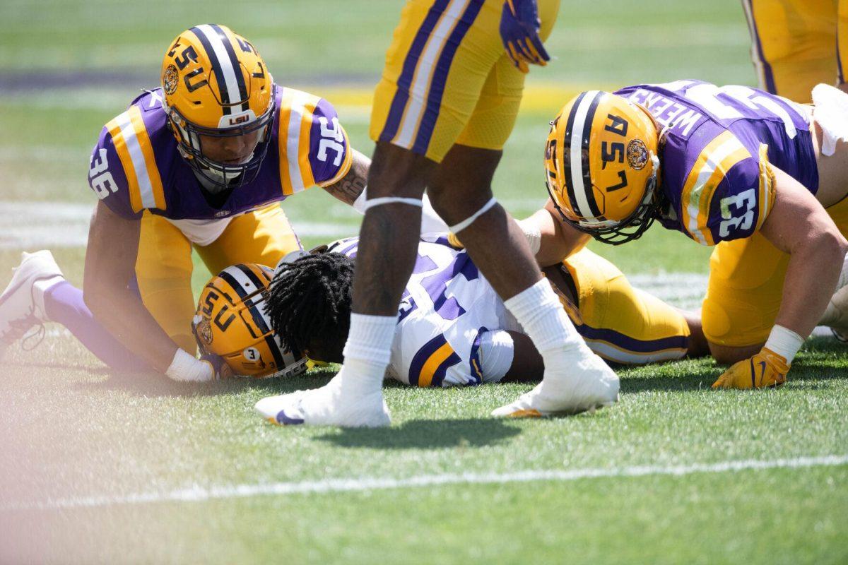 LSU football redshirt freshman running back Joseph Ebun (32) loses his helmet after being tackled during the LSU Spring Football game on Saturday, April 13, 2024, in Tiger Stadium.