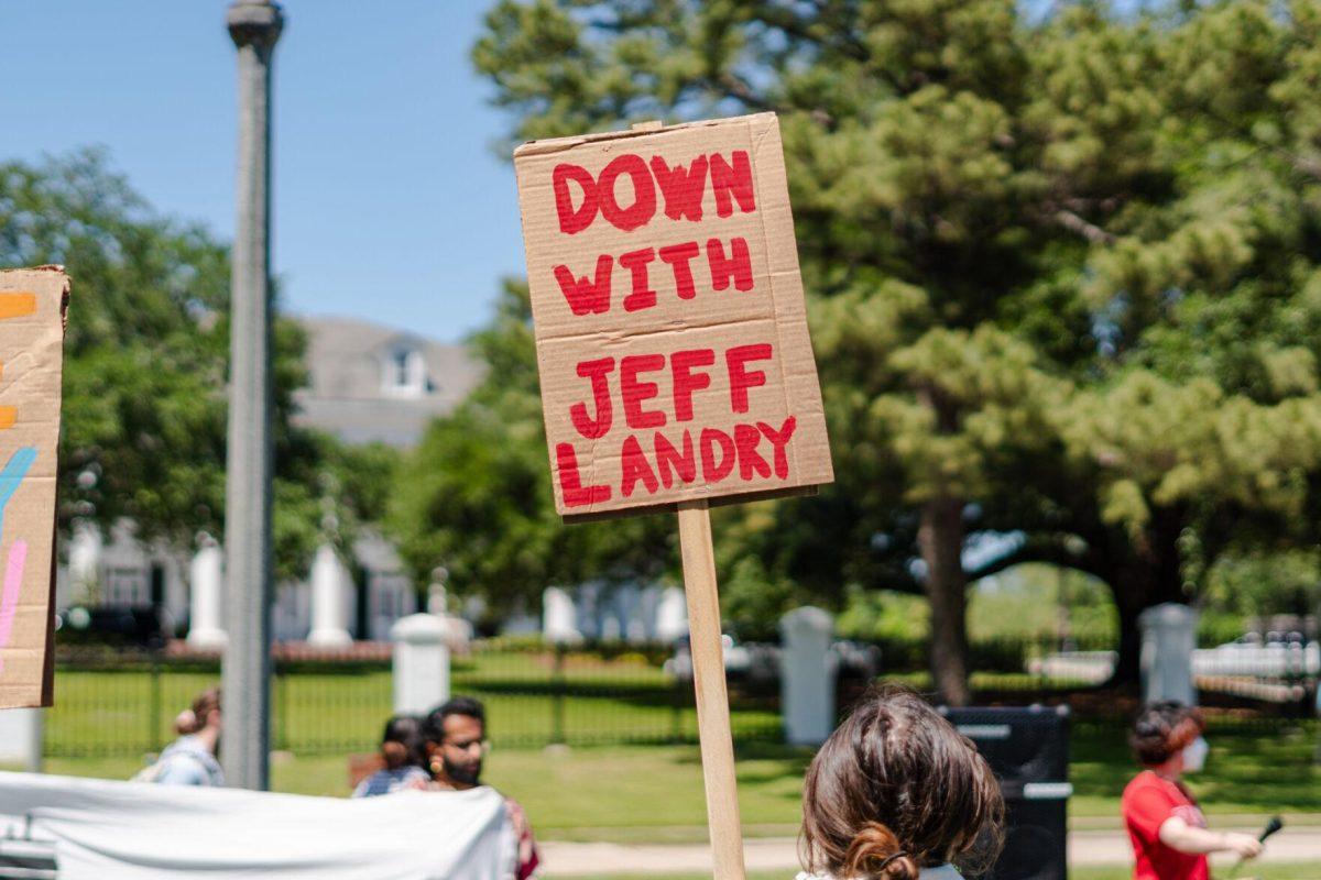 A sign reads "Down with Jeff Landry" Monday, April 22, 2024, during a protest outside the Governor's mansion in Baton Rouge, La.