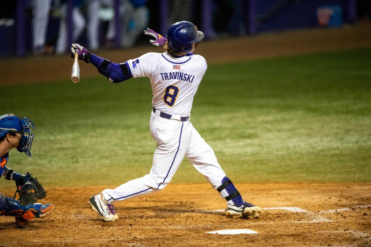 LSU baseball graduate student catcher Hayden Travinski (8) hits the ball during LSU's 6-4 loss against Florida on Saturday, March 23, 2024, at Alex Box Stadium in Baton Rouge, La.