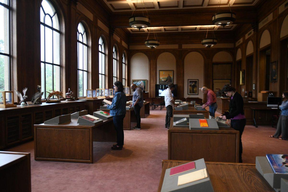 Visitors look at pieces of poetry during the Afternoon in the Archives: The Wyatt Houston Day Collection of Poetry by African Americans event at Hill Memorial Library on Thursday, April 18, 2024, on LSU campus in Baton Rouge, La.