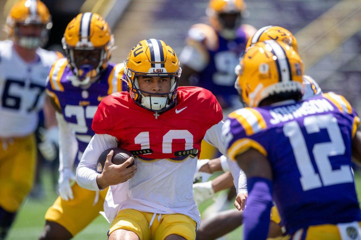 LSU football redshirt freshman quarterback Rickie Collins (10) plans his next move while running the ball during the LSU Spring Football game on Saturday, April 13, 2024, in Tiger Stadium.