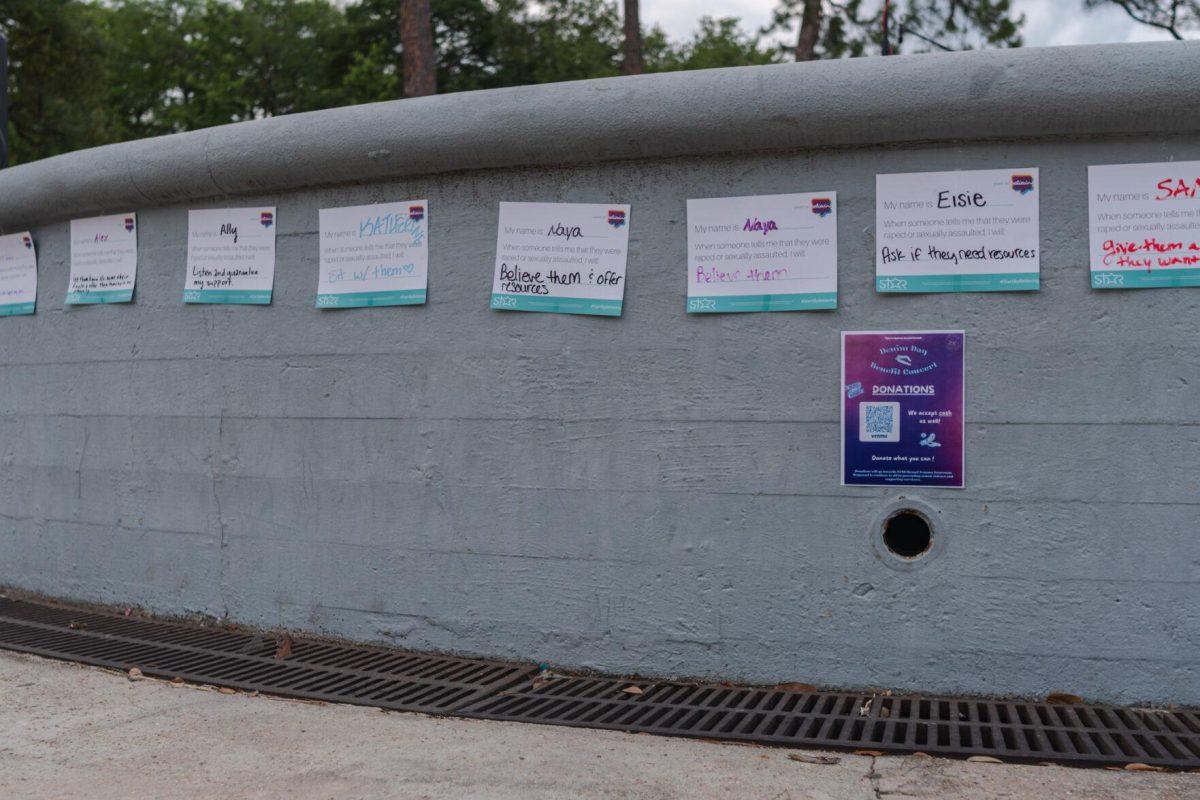 Papers read what various people would do to support someone who reveals an experience of sexual assault Wednesday, April 24, 2024, during a Denim Day event at the LSU amphitheater.