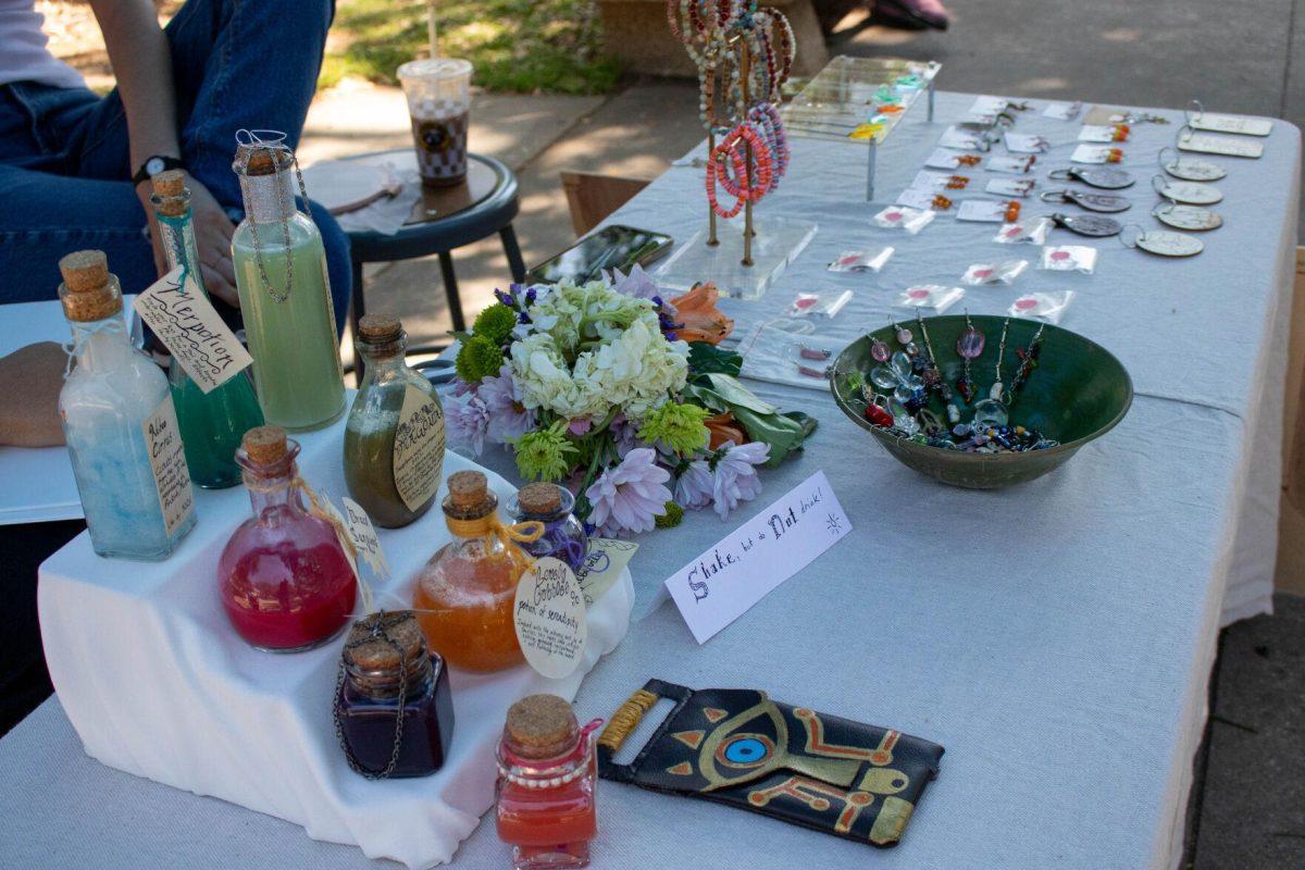 A variety of student's work sits on the table to be sold on Wednesday, April 24, 2024, in Free Speech Alley on LSU's campus.