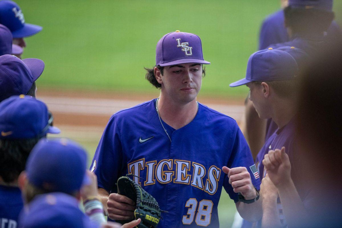 LSU baseball junior right-handed pitcher Luke Holman (38) fist-bumps his teammates during LSU's 6-4 win on Saturday, May 4, 2024, at Alex Box Stadium in Baton Rouge, La.