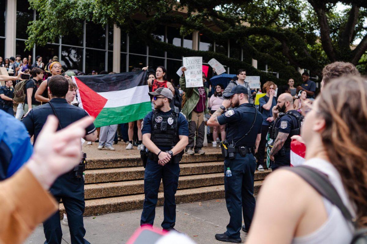 Police officers stand between the two groups of protesters Friday, May 3, 2024, in Free Speech Alley on LSU's campus in Baton Rouge, La.