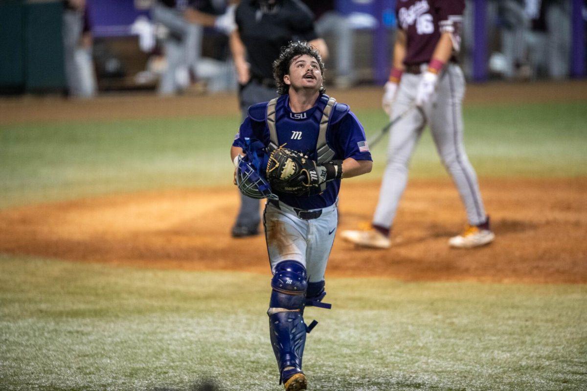 LSU baseball graduate student catcher Alex Milazzo (7) runs to catch a foul ball during LSU's 6-4 win on Saturday, May 4, 2024, at Alex Box Stadium in Baton Rouge, La.