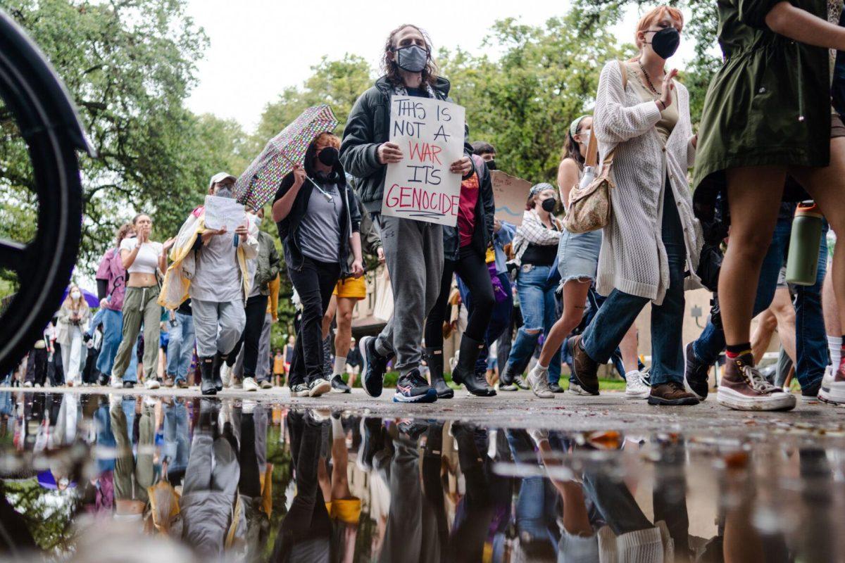 Pro-Palestinian protesters march Friday, May 3, 2024, down Tower Drive on LSU's campus in Baton Rouge, La.