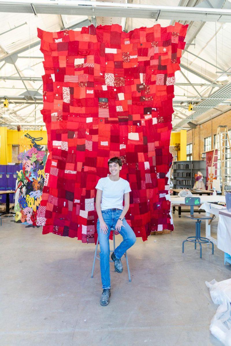 LSU 5th-year sculpture major Adrianna Hawkins sits in front of the quilt Wednesday, May 1, 2024, inside the Barnes Ogden Art &amp; Design Complex on LSU's campus in Baton Rouge, La.