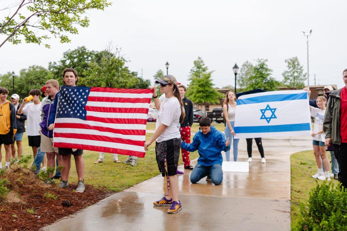 A pair holding an Israeli flag joins those holding the American flag Friday, May 3, 2024, outside of Patrick F. Taylor Hall on LSU's campus in Baton Rouge, La.