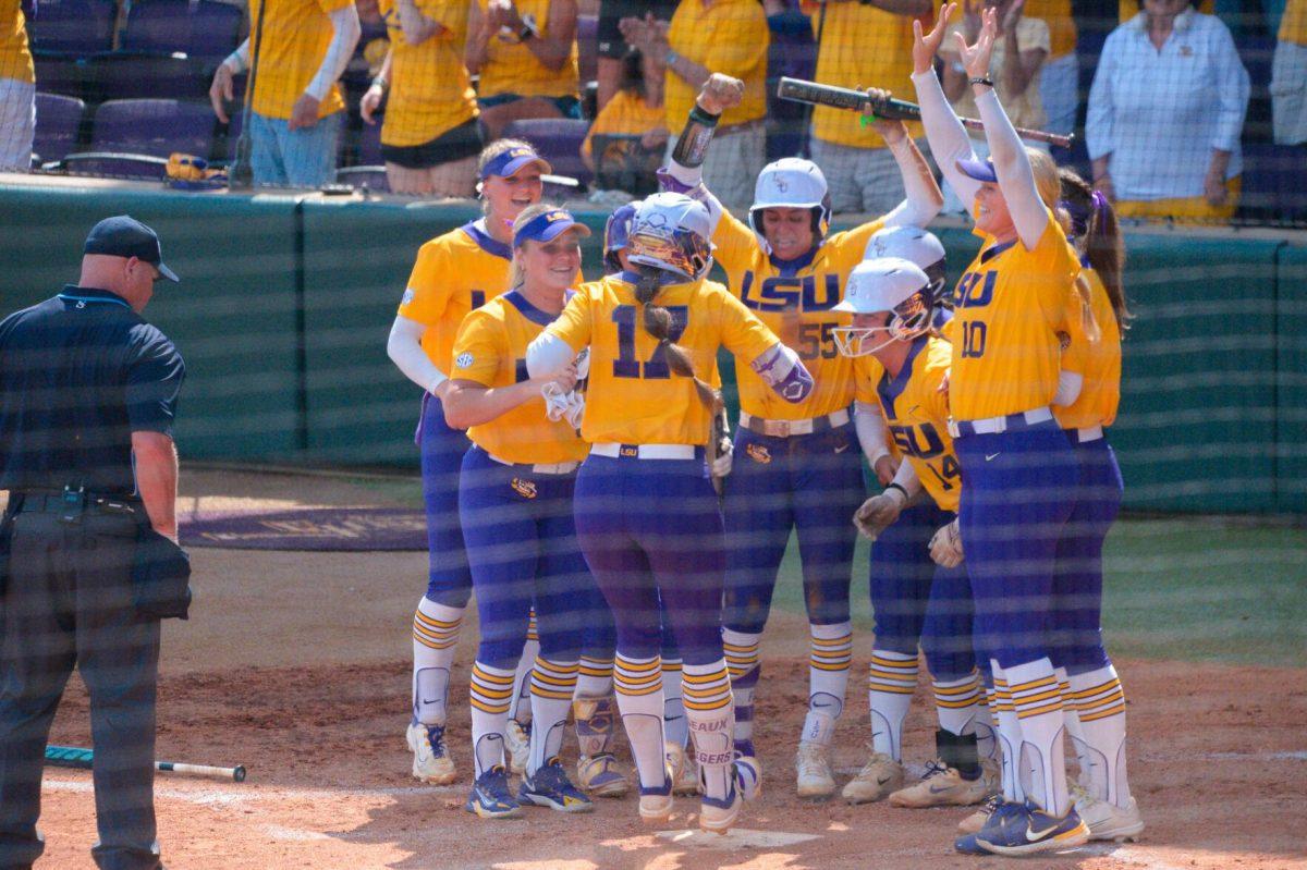 LSU softball players celebrate graduate student Taylor Pleasants (12) homerun on Sunday, May 19, 2024,&#160;during LSU's&#160;9-0 win against Southern Illinois in the&#160;NCAA Regional Championship game at Tiger Park in Baton Rouge, La.