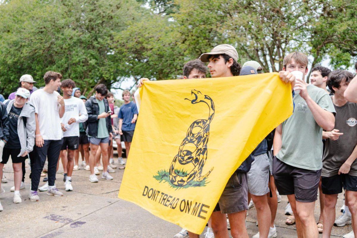 A counter-protester holds a "Don't tread on me" flag Friday, May 3, 2024, in Free Speech Alley on LSU's campus in Baton Rouge, La.