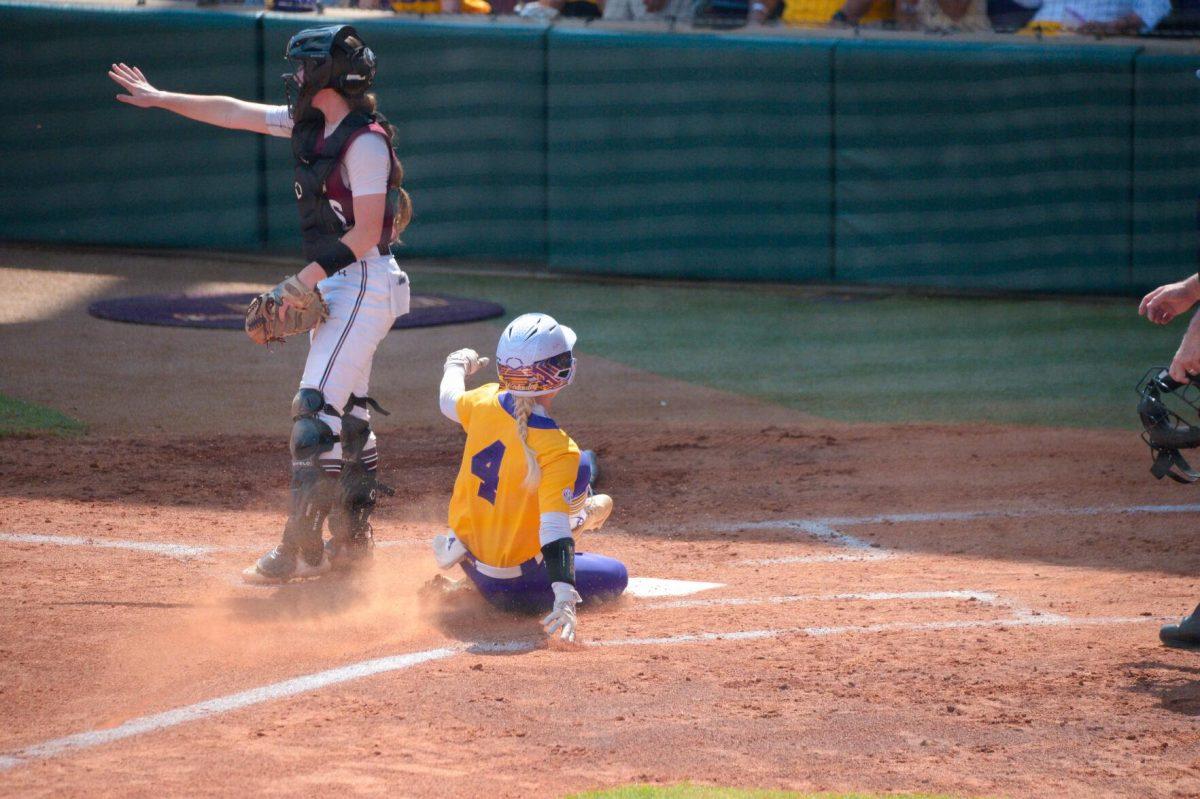 LSU softball junior outfield McKenzie Redoutey (4) slides into home on Sunday, May 19, 2024,&#160;during LSU's&#160;9-0 win against Southern Illinois in the&#160;NCAA Regional Championship game at Tiger Park in Baton Rouge, La.