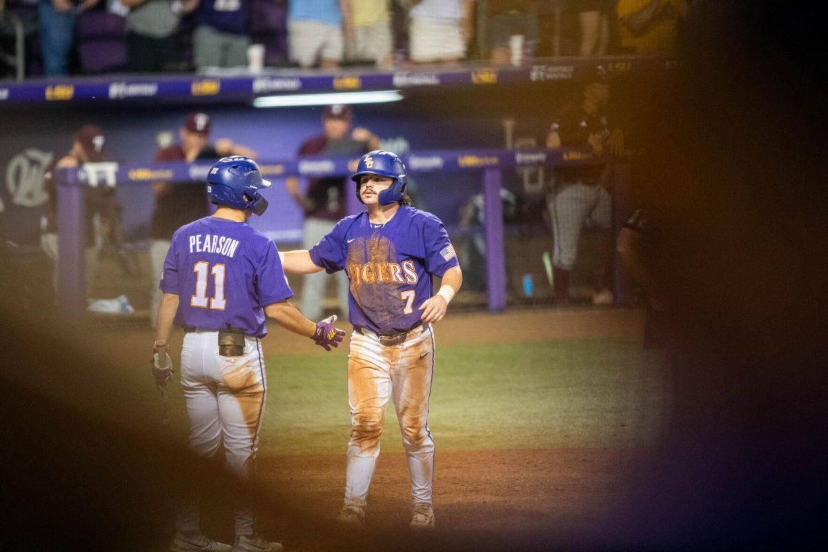 LSU baseball graduate student catcher Alex Milazzo (7) high fives teammate Josh Pearson (11) after his homerun during LSU's 6-4 win on Saturday, May 4, 2024, at Alex Box Stadium in Baton Rouge, La.