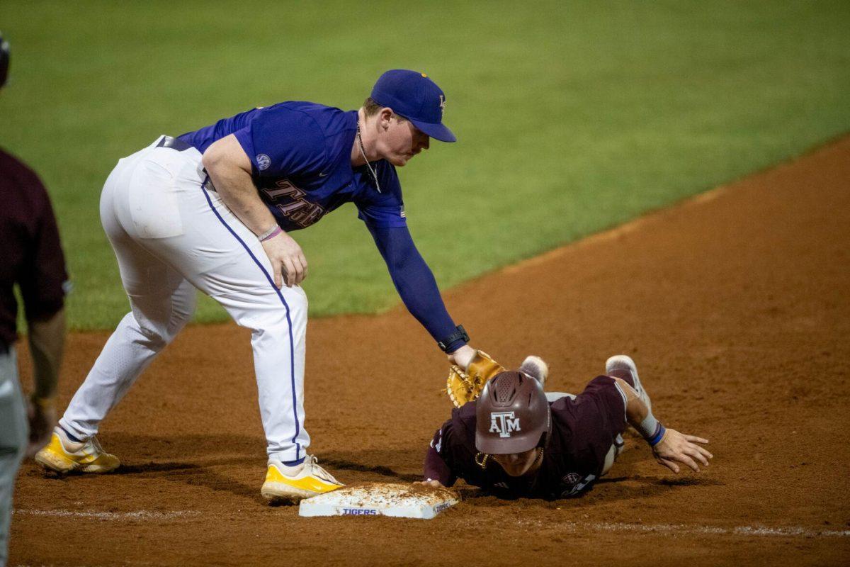 LSU baseball sophomore first basemen Jared Jones (22) tags the A&amp;M player at first base during LSU's 6-4 win on Saturday, May 4, 2024, at Alex Box Stadium in Baton Rouge, La.