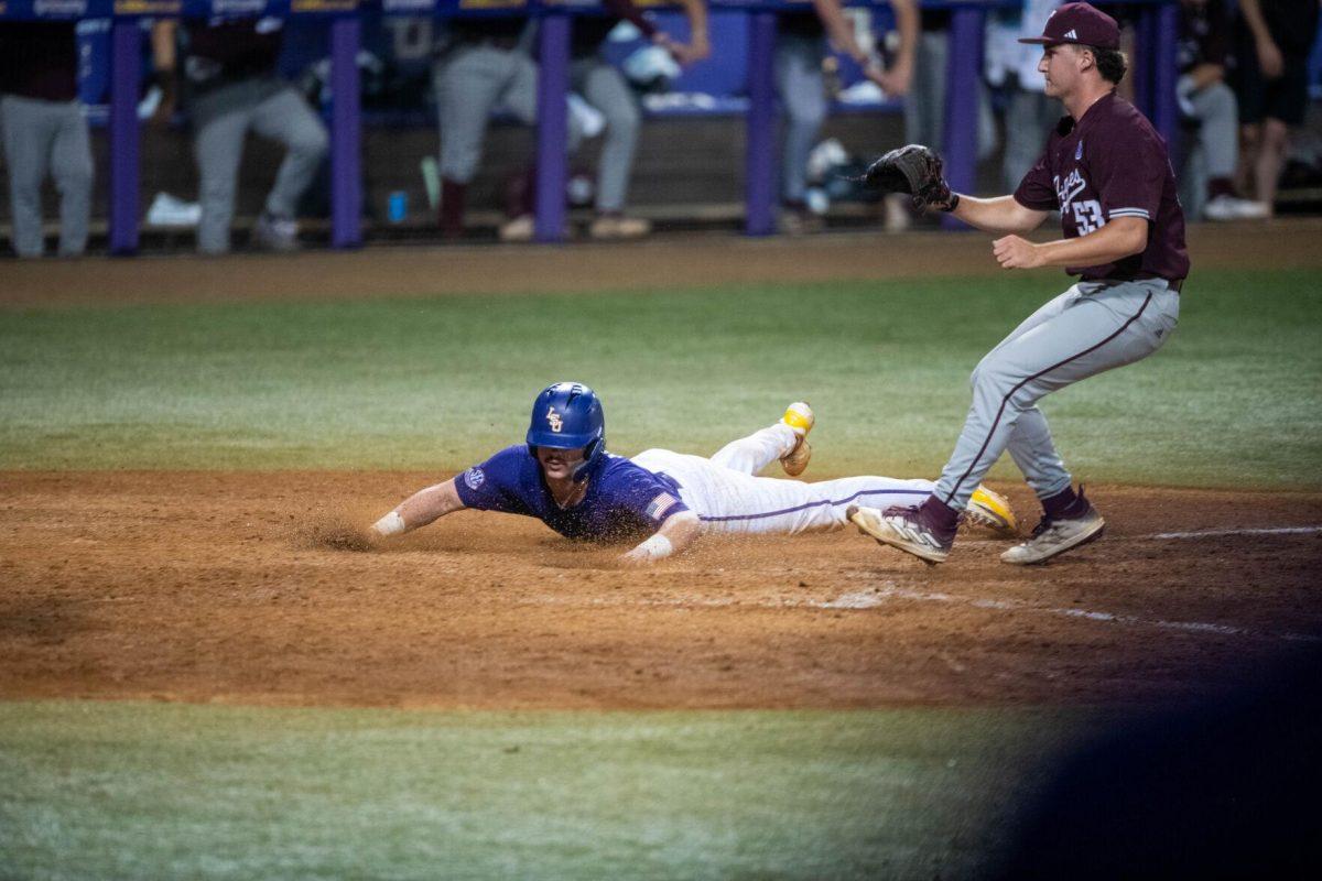 LSU baseball graduate student catcher Alex Milazzo (7) slides into home plate during LSU's 6-4 win on Saturday, May 4, 2024, at Alex Box Stadium in Baton Rouge, La.