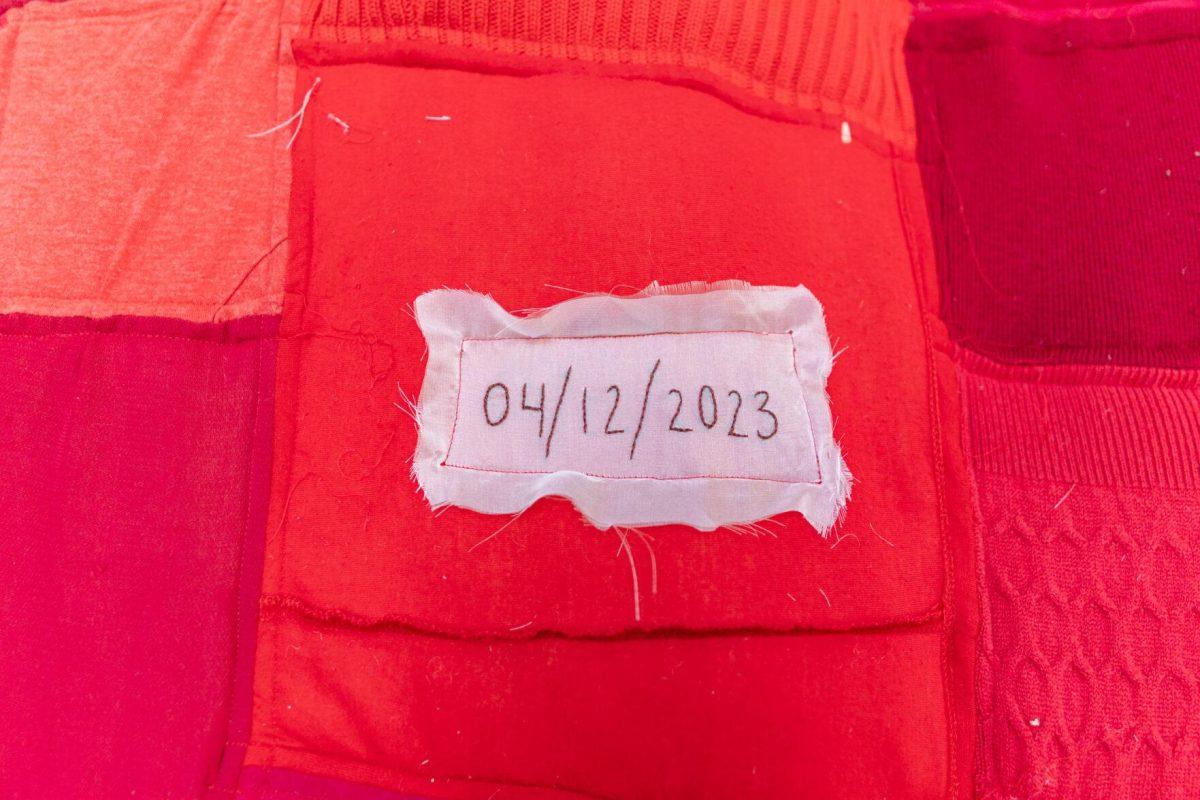 The numerals of the date "April 12, 2023" stitched in a dark thread represents a formally resolved case Wednesday, May 1, 2024, inside the Barnes Ogden Art &amp; Design Complex on LSU's campus in Baton Rouge, La.