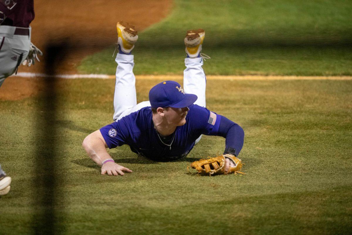 LSU baseball sophomore first basemen Jared Jones (22) slides to stop a ground ball during LSU's 6-4 win on Saturday, May 4, 2024, at Alex Box Stadium in Baton Rouge, La.