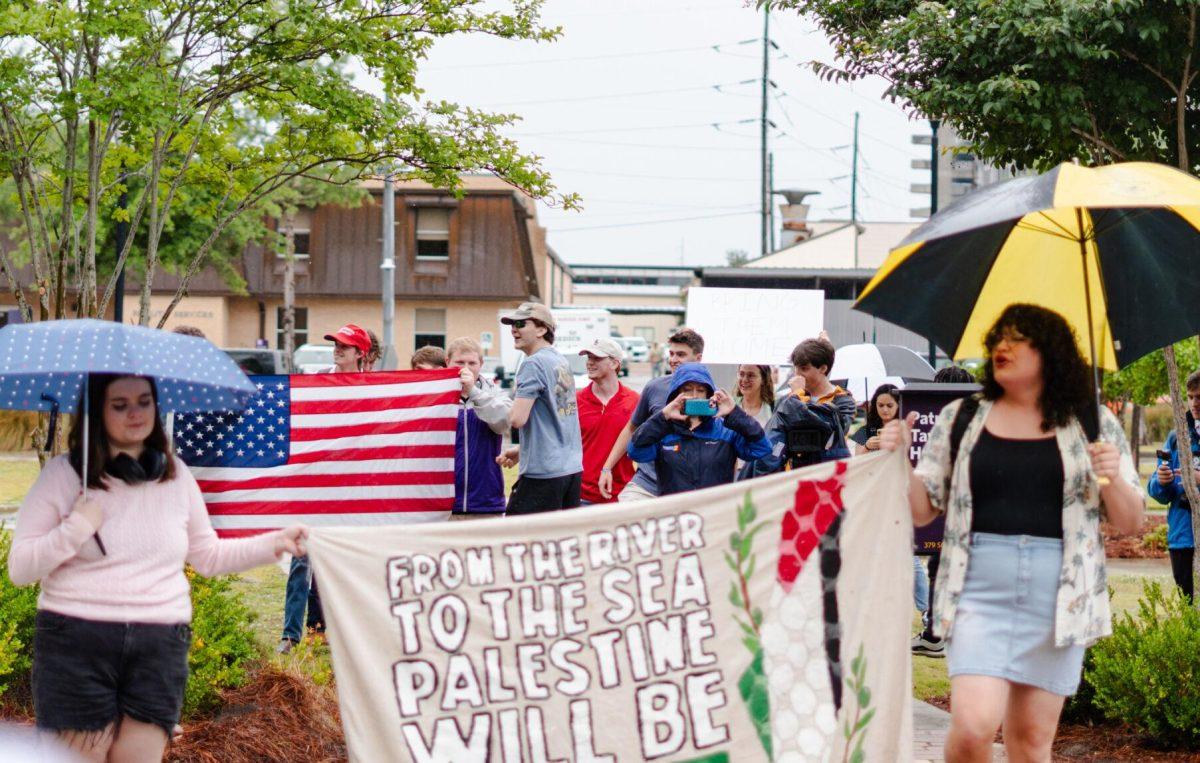 Counter-protesters hold up an American flag behind the Pro-Palestinian protesters Friday, May 3, 2024, outside of Patrick F. Taylor Hall on LSU's campus in Baton Rouge, La.